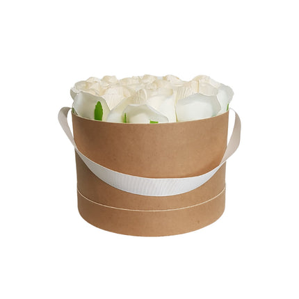White artificial roses in a cardboard hatbox with a decorative ribbon handle